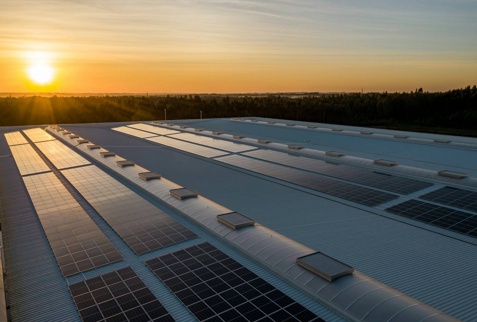 Industrial rooftop solar plant at sunset